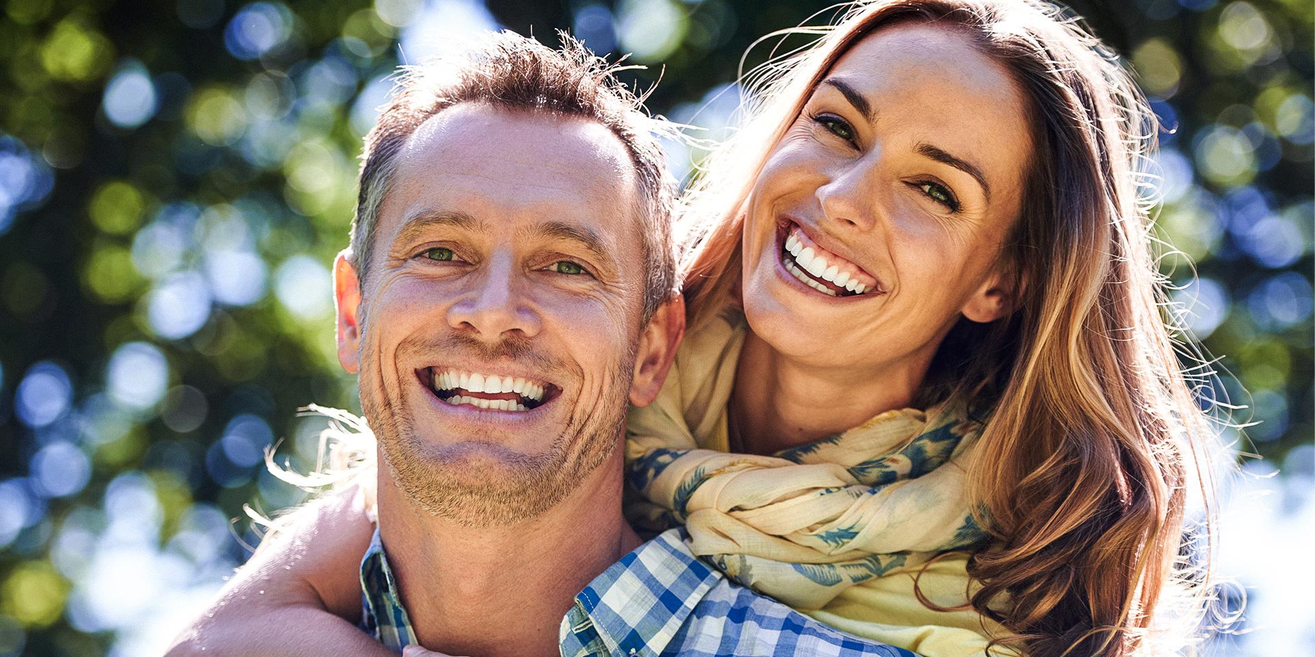 Happy couple with nice smiles from dental implants